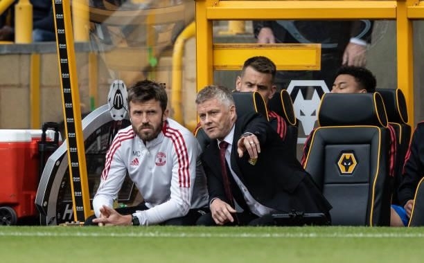 Manchester United's coach Michael Carrick chats with manager Ole Gunnar Solskjaer in the dugout during the Premier League match between Wolverhampton...