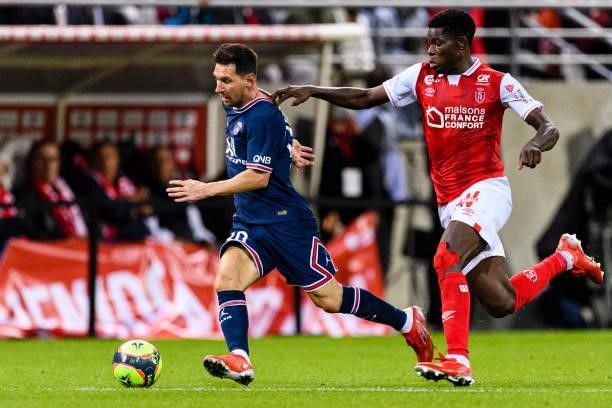 Lionel Messi of Paris Saint Germain is chased by Marshall Munetsi of Reims during his debut for PSG during the Ligue 1 Uber Eats match between Reims...