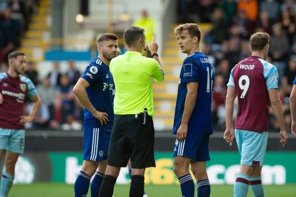 Diego Llorente of Leeds United is talked to by Michael Oliver, the match referee, during the Premier League match between Burnley and Leeds United at...