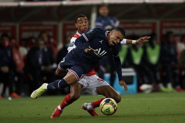 Kylian Mbappe of PSG and Hugo Ekitike of Reims compete for the ball during the Ligue 1 Uber Eats match between Reims and Paris Saint Germain at Stade...