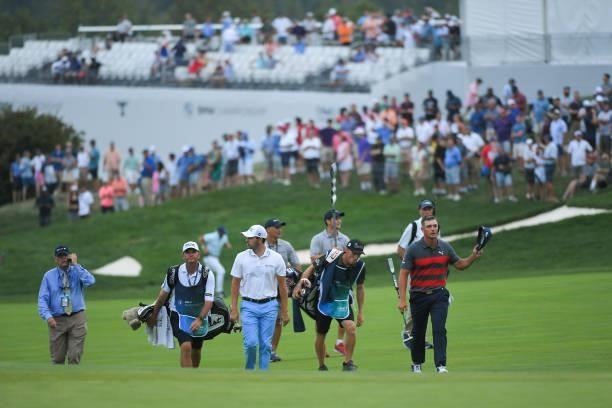 Bryson DeChambeau and Patrick Cantlay walk up the 18th fairway in the sixth playoff hole during the final round of the BMW Championship at Caves...