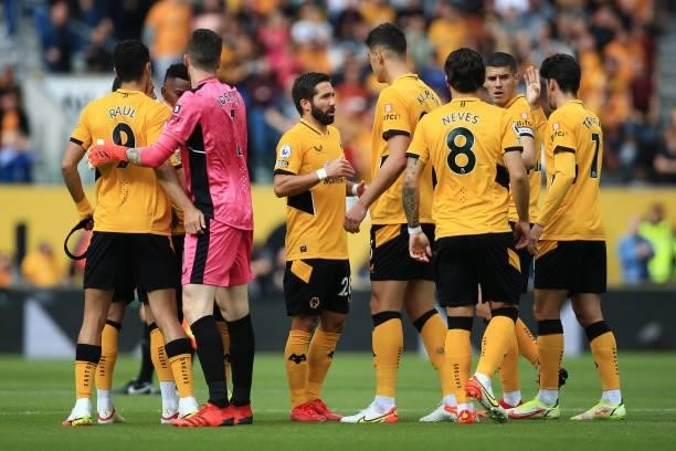 Joao Moutinho of Wolverhampton Wanderers stands at the centre of a team talk before the Premier League match between Wolverhampton Wanderers and...