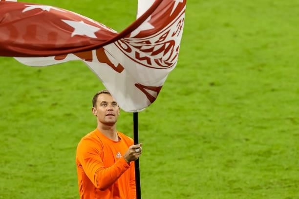 Goalkeeper Manuel Neuer of Bayern Muenchen carry a flag after the Bundesliga match between FC Bayern Muenchen and Hertha BSC at Allianz Arena on...