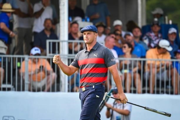 Bryson DeChambeau celebrates with a fist pump after making a birdie putt on the 16th hole green during the final round of the BMW Championship, the...
