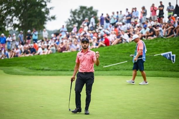 Abraham Ancer of Mexico waves his ball to fans on the 14th hole green during the final round of the BMW Championship, the second event of the...