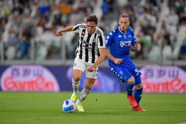 Juventus player Federico Chiesa and Empoli player Adrian Ismajli during the Serie A match between Juventus and Empoli FC at Allianz Stadium on August...