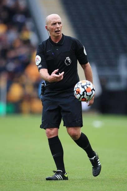Referee Mike Dean throws the ball away during the Premier League match between Wolverhampton Wanderers and Manchester United at Molineux on August...