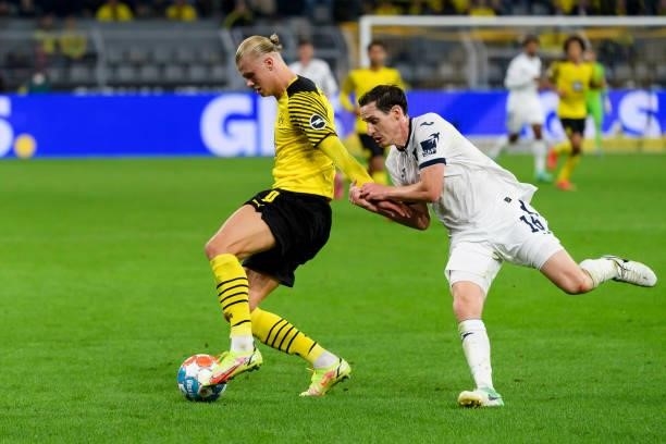 Erling Haaland of Borussia Dortmund and Sebastian Rudy of TSG Hoffenheim battle for the ball during the Bundesliga match between Borussia Dortmund...