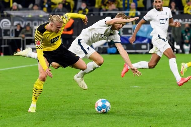 Erling Haaland of Borussia Dortmund and Stefan Posch of TSG Hoffenheim battle for the ball during the Bundesliga match between Borussia Dortmund and...