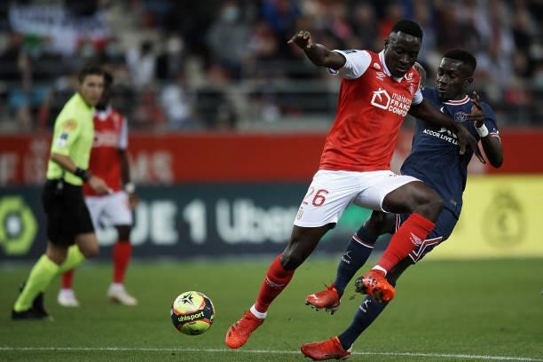Dion Lopy of Reims and Idrissa Gueye of PSG compete for the ball during the Ligue 1 Uber Eats match between Reims and Paris Saint Germain at Stade...