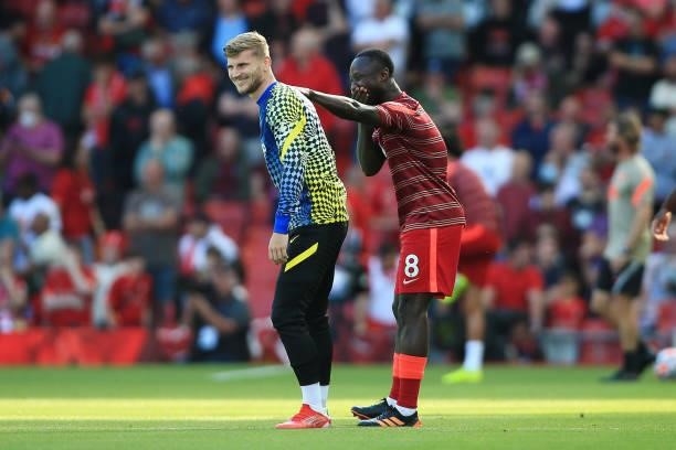 Timo Werner of Chelsea and Naby Keita of Liverpool share a joke before the Premier League match between Liverpool and Chelsea at Anfield on August...