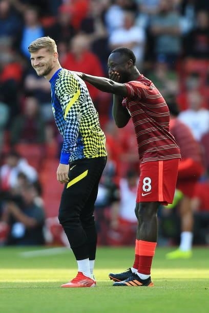 Timo Werner of Chelsea and Naby Keita of Liverpool share a joke before the Premier League match between Liverpool and Chelsea at Anfield on August...