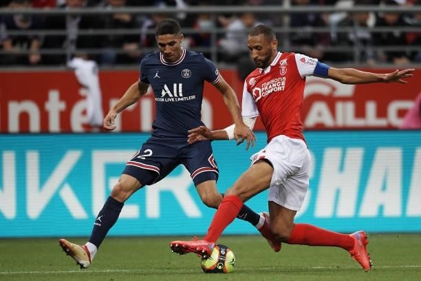 Achraf Hakimi of PSG and Yunis Abdelhamid of Reims compete for the ball during the Ligue 1 Uber Eats match between Reims and Paris Saint Germain at...