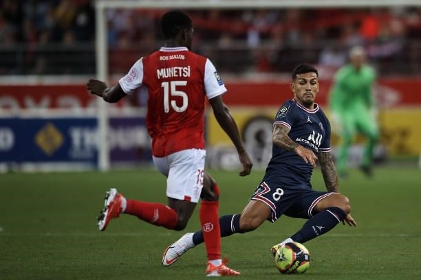 Leandro Paredes of PSG and Marshall Munetsi of Reims compete for the ball during the Ligue 1 Uber Eats match between Reims and Paris Saint Germain at...