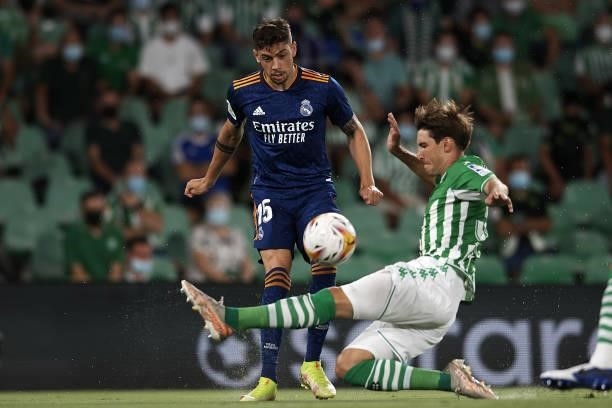 Federico Valverde of Real Madrid and Juan Miranda of Betis compete for the ball during the La Liga Santader match between Real Betis and Real Madrid...