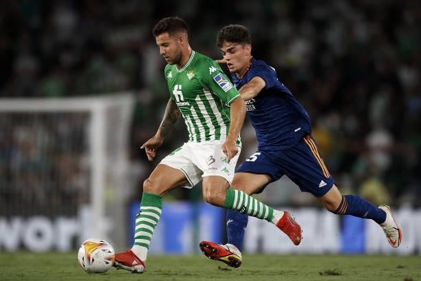Aitor Ruibal of Betis and Miguel Ortega Gutierrez of Real Madrid compete for the ball during the La Liga Santader match between Real Betis and Real...