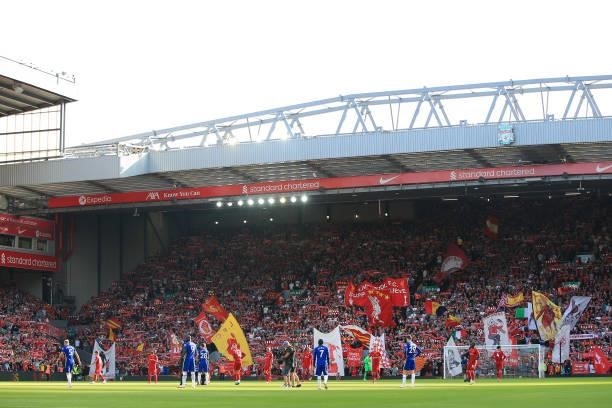 Liverpool fans wave their flags and banners in The Kop before the Premier League match between Liverpool and Chelsea at Anfield on August 28, 2021 in...