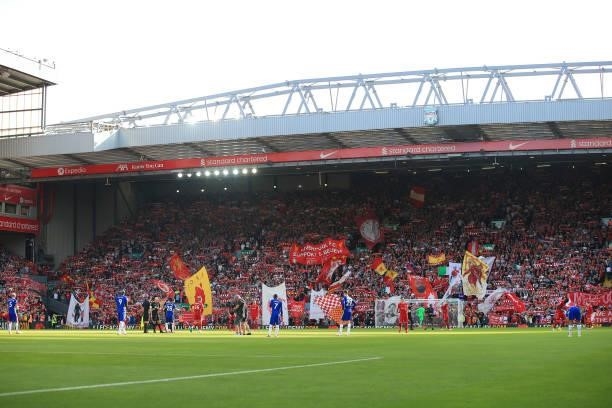 Liverpool fans wave their flags and banners in The Kop before the Premier League match between Liverpool and Chelsea at Anfield on August 28, 2021 in...