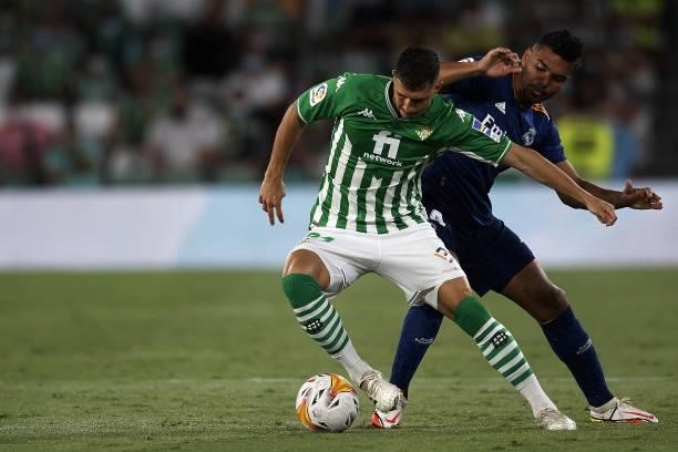 Guido Rodriguez of Betis and Casemiro of Real Madrid compete for the ball during the La Liga Santader match between Real Betis and Real Madrid CF at...