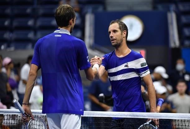 France's Richard Gasquet shakes hands with Russia's Daniil Medvedev after Medvedev won their 2021 US Open Tennis tournament men's singles first round...