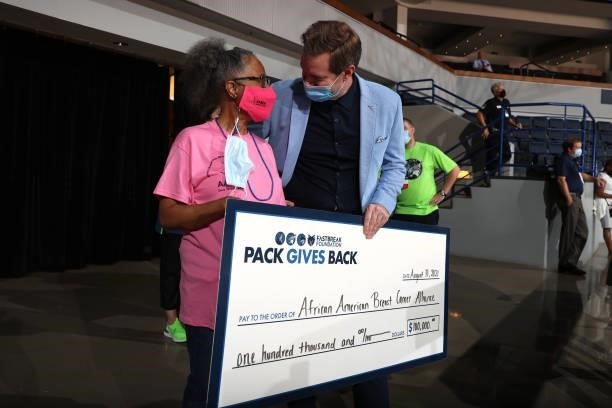 Reona Berry of the African American Breast Cancer Alliance is presented a check during the Minnesota Lynx game against the New York Liberty on August...