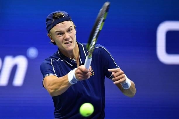 Denmark's Holger Rune hits a return to Serbia's Novak Djokovic during their 2021 US Open Tennis tournament men's singles first round match at the...
