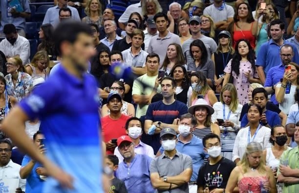 Spectators listen as Serbia's Novak Djokovic speaks after winning his 2021 US Open Tennis tournament men's singles first round match against...