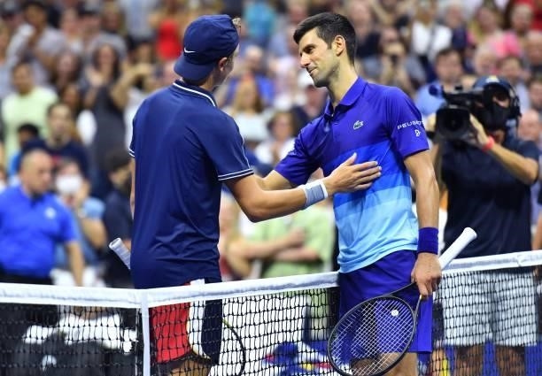 Serbia's Novak Djokovic greets Denmark's Holger Rune at the net after winning their 2021 US Open Tennis tournament men's singles first round match at...