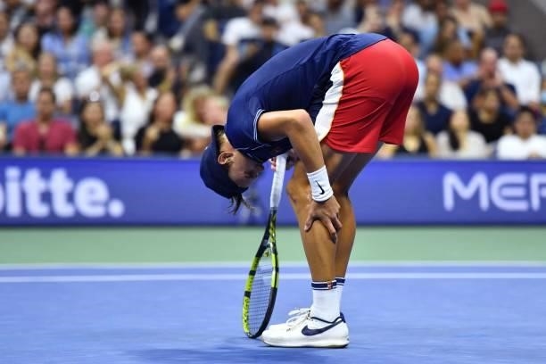 Denmark's Holger Rune touches his leg during his 2021 US Open Tennis tournament men's singles first round match against Serbia's Novak Djokovic at...