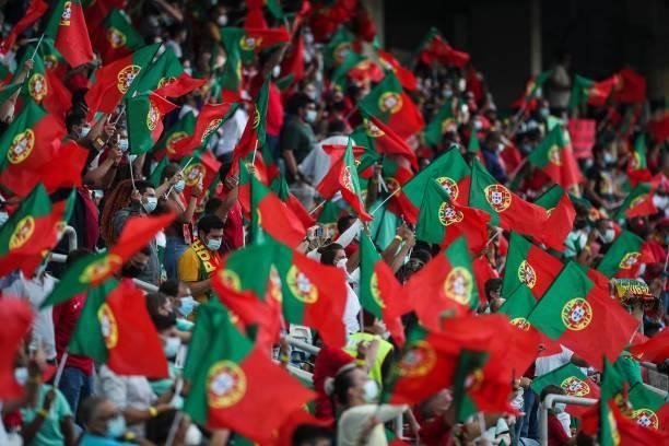 Supporters wave flags of Portugal during the FIFA World Cup Qatar 2022 European qualifying round group A football match between Portugal and Republic...