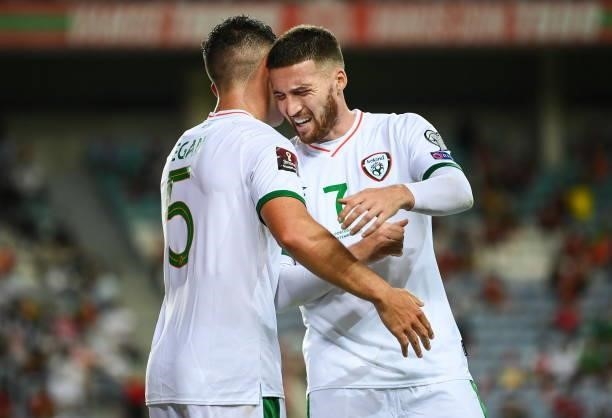 Faro , Portugal - 1 September 2021; John Egan of Republic of Ireland celebrates with team-mate Matt Doherty, right, after scoring his side's first...