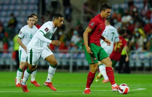 Joao Palhinha of Sporting CP and Portugal with Adam Idah of Republic of Ireland and Norwich City in action during the World Cup 2022 Qualifier match...