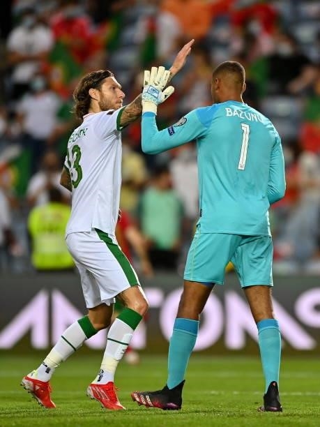 Faro , Portugal - 1 September 2021; Gavin Bazunu of Republic of Ireland is congratulated by team-mate Jeff Hendrick after saving a penalty from...