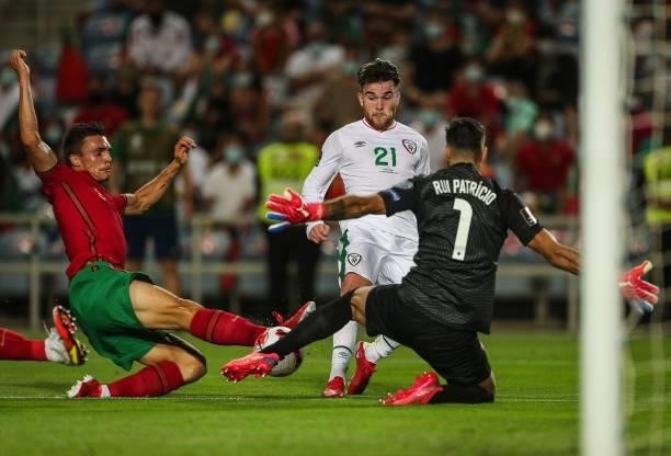 Republic of Ireland's forward Aaron Connolly fights with Portugal's defender Joao Palhinha and Portugal's goalkeeper Rui Patricio during the FIFA...