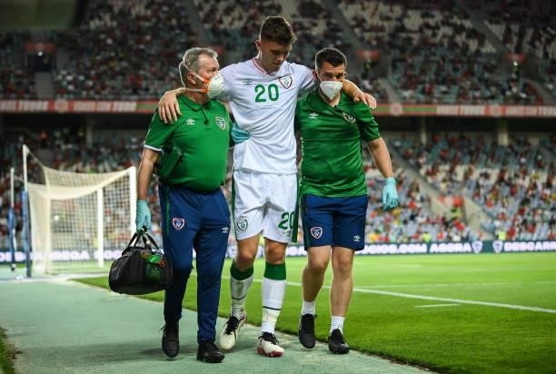 Faro , Portugal - 1 September 2021; Dara O'Shea of Republic of Ireland is assisted from the pitch by Republic of Ireland team doctor Alan Byrne,...