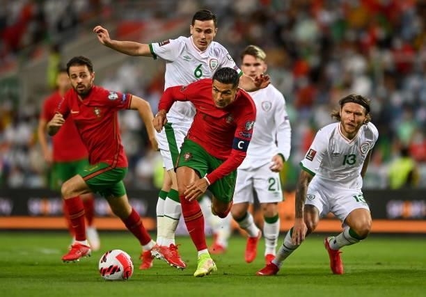 Faro , Portugal - 1 September 2021; Cristiano Ronaldo of Portugal in action against Josh Cullen, left, and Jeff Hendrick of Republic of Ireland...