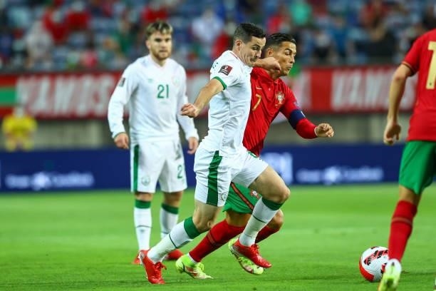 Cristiano Ronaldo of Manchester United and Portugal tries to escape Josh Cullen of Republic of Ireland and Anderlecht during the 2022 FIFA World Cup...