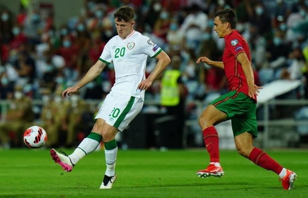 Dara O'Shea of Republic of Ireland and West Bromwich Albion with Joao Palhinha of Sporting CP and Portugal in action during the World Cup 2022...