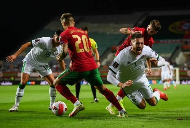 Faro , Portugal - 1 September 2021; Matt Doherty of Republic of Ireland in action against Rafa Silva, right, and João Cancelo of Portugal during the...