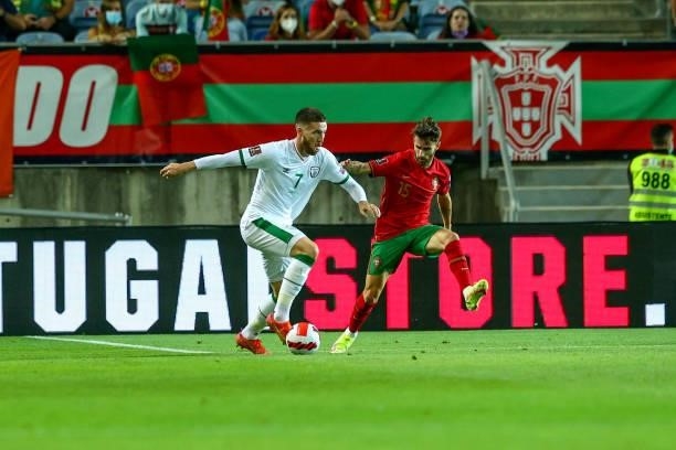 Matt Doherty of Republic of Ireland and Tottenham Hotspur tries to pass trought Rafa Silva of SL Benfica and Portugal during the 2022 FIFA World Cup...