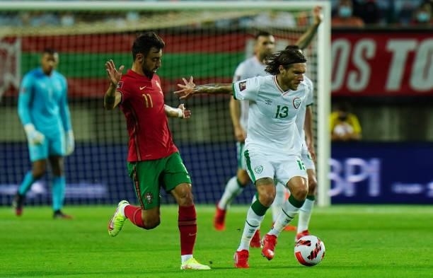 Jeff Hendrick of Republic of Ireland and Newcastle United with Bruno Fernandes of Manchester United and Portugal in action during the World Cup 2022...