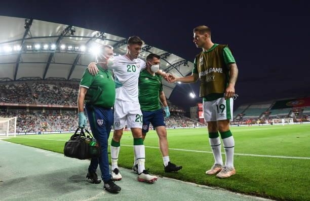 Faro , Portugal - 1 September 2021; Dara O'Shea of Republic of Ireland is greeted by James Collins, right, as he is assisted from the pitch by...