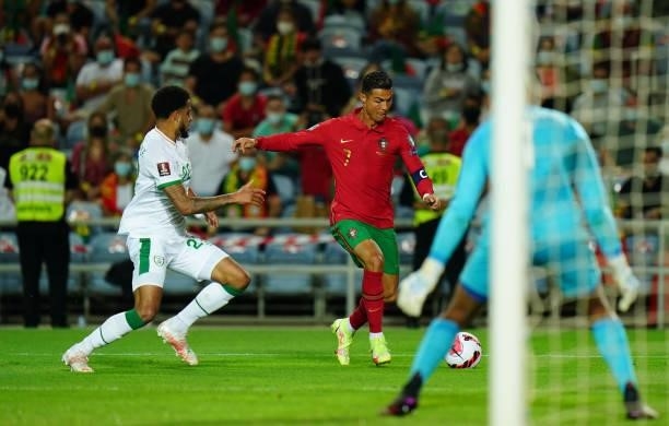 Cristiano Ronaldo of Manchester United and Portugal with Andrew Omobamidele of Republic of Ireland and Norwich City in action during the World Cup...