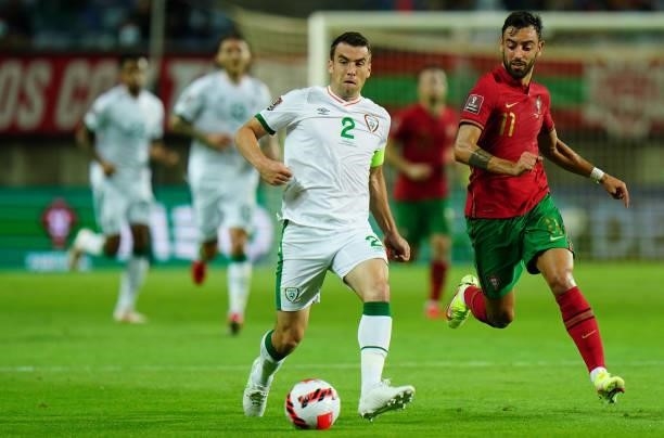 Seamus Coleman of Republic of Ireland and Everton with Bruno Fernandes of Manchester United and Portugal in action during the World Cup 2022...