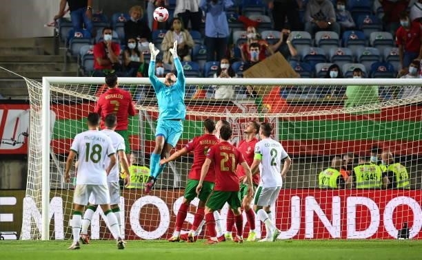 Faro , Portugal - 1 September 2021; Republic of Ireland goalkeeper Gavin Bazunu gathers possession ahead of Cristiano Ronaldo of Portugal during the...