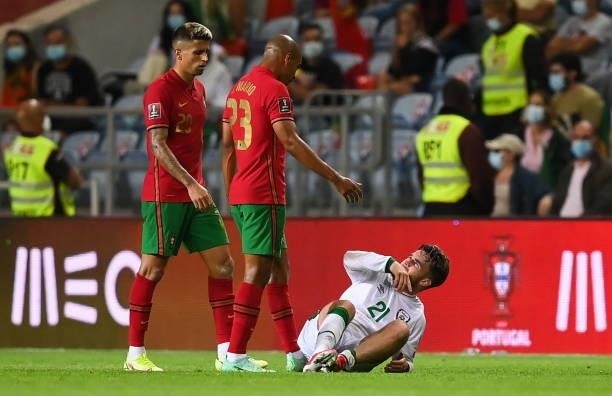 Faro , Portugal - 1 September 2021; Aaron Connolly of Republic of Ireland is confronted by João Mário, right, and João Cancelo of Portugal after...