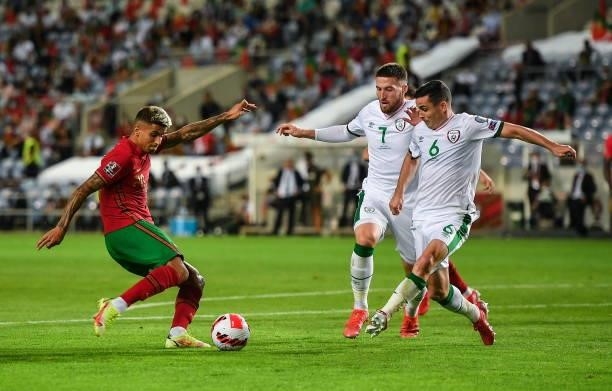 Faro , Portugal - 1 September 2021; João Cancelo of Portugal in action against Matt Doherty and Josh Cullen of Republic of Ireland during the FIFA...