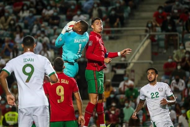 Portugal's forward Cristiano Ronaldo fights for the ball with Republic of Ireland's goalkeeper Gavin Bazunu during the FIFA World Cup Qatar 2022...
