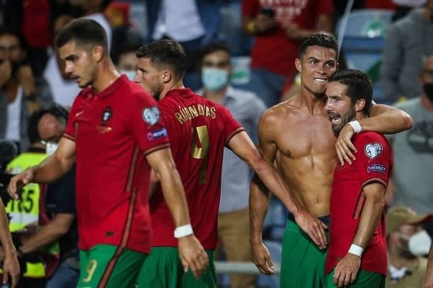 Portugal's forward Cristiano Ronaldo celebrates with his teammates after scoring a goal during the FIFA World Cup Qatar 2022 European qualifying...
