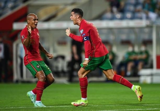 Faro , Portugal - 1 September 2021; Cristiano Ronaldo of Portugal, right, celebrates with team-mate João Mário after scoring their side's first goal...